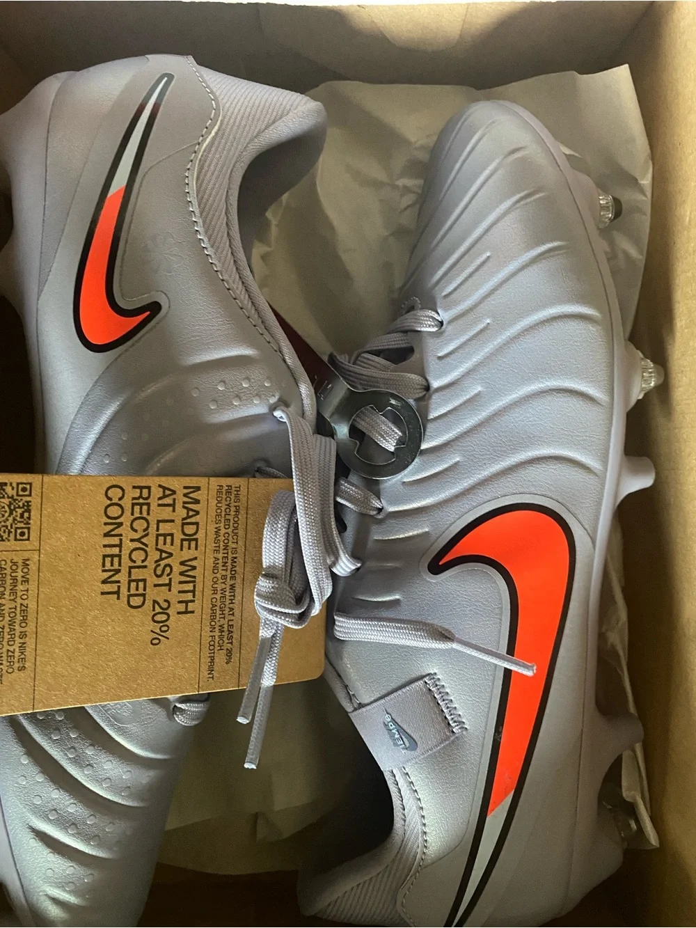 Nike Kids Gray Soccer Cleats with Orange Swoosh